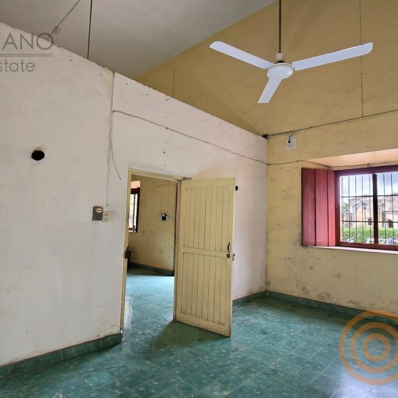 Habitación con ventana de persianas rosas y piso turquesa