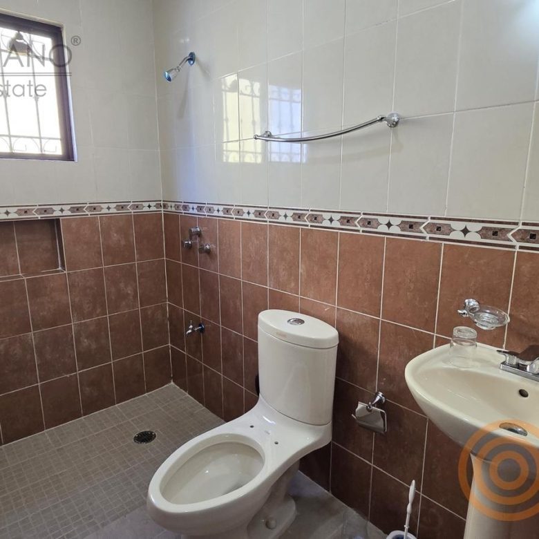 Baño completo con azulejo terracota y lavabo