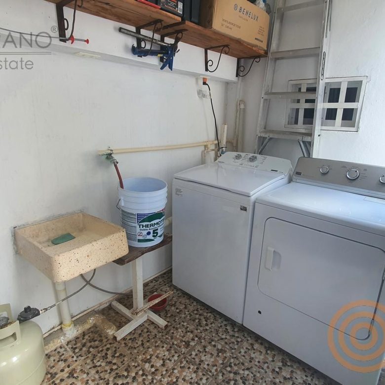 Área de lavandería con lavadero, lavadora y secadora