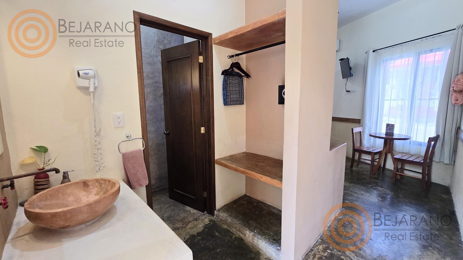 bre-hv-56sisal-09 Lavabo de piedra y área de clóset en una habitación del hotel