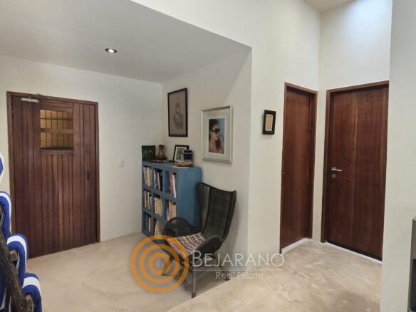 Vestíbulo con puertas de madera y librero de casa en Valladolid